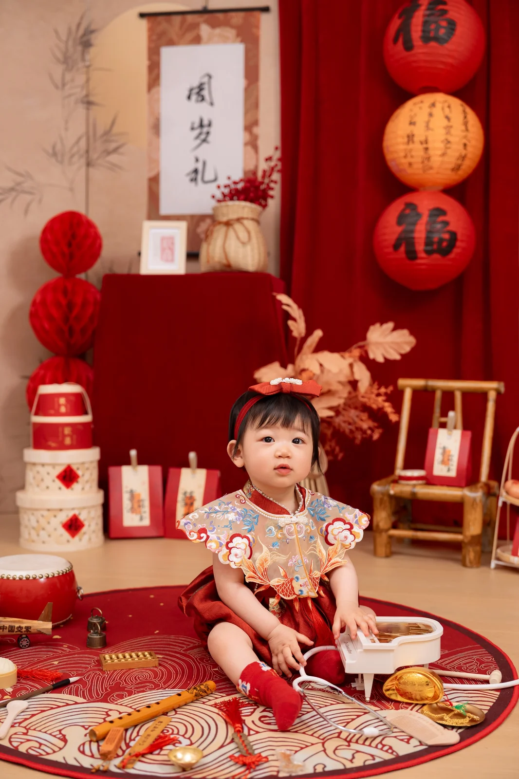 Smiling baby sitting beside a first birthday cake during a simple studio cake smash session