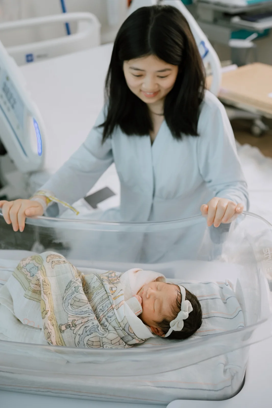 Mother cuddling her newborn baby during a quiet in-home newborn session