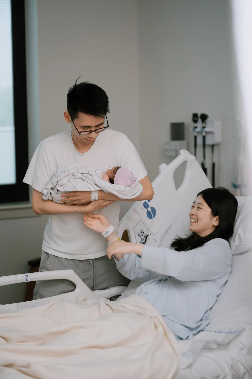Newborn baby resting safely in a parent's hands during a studio newborn portrait