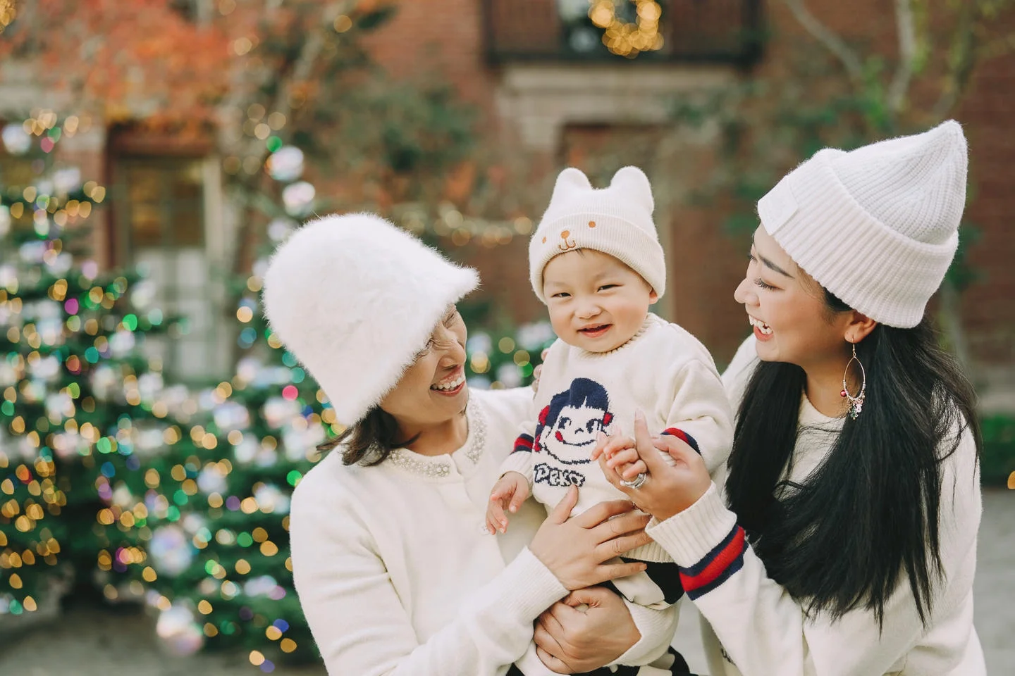 Mother holding her smiling toddler during an outdoor family photo session